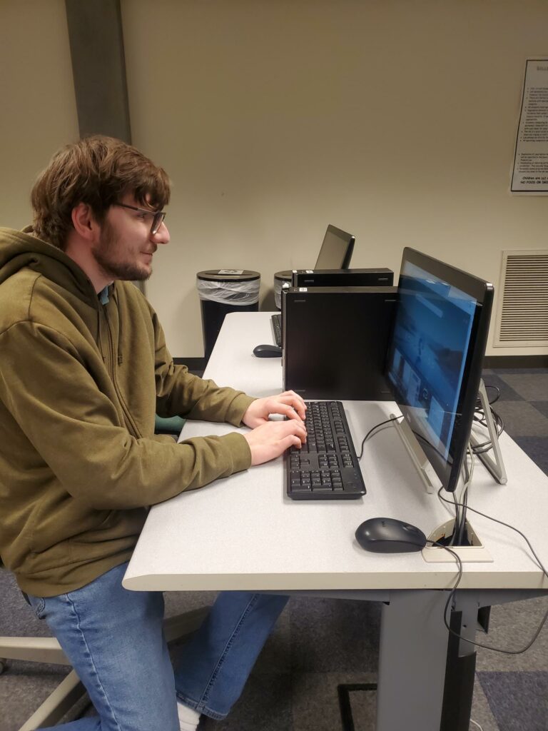 OLSBC student doing research on a computer for a mock interview