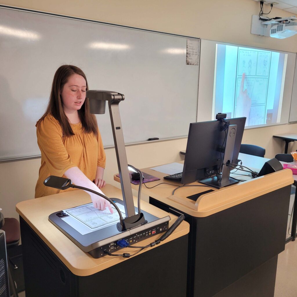 an OLSBC student presents a comic in class