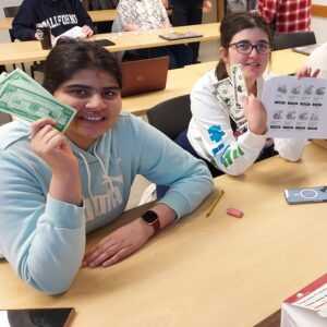 Two OLSBC students practicing personal finance