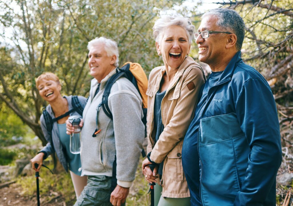 Group of mature adults on a hike, laughing