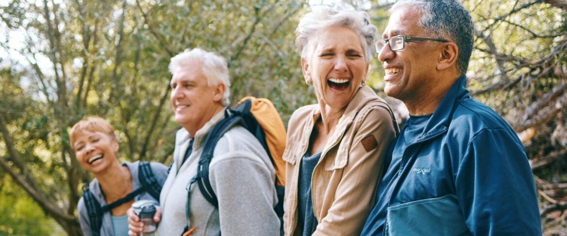 Group of mature adults hiking and laughing