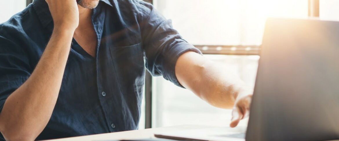 Male sitting in front of a laptop