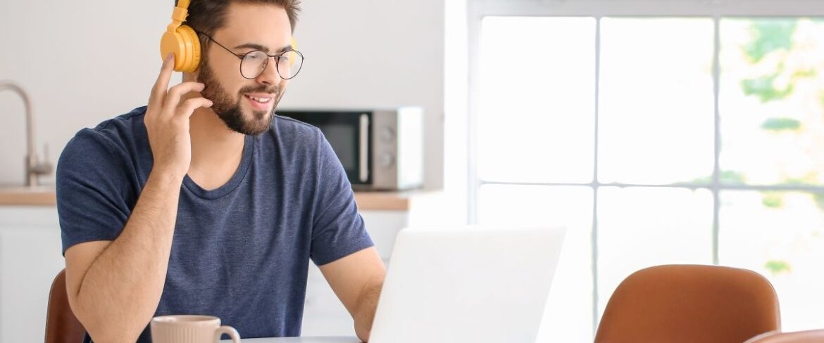 Male at computer with headset on