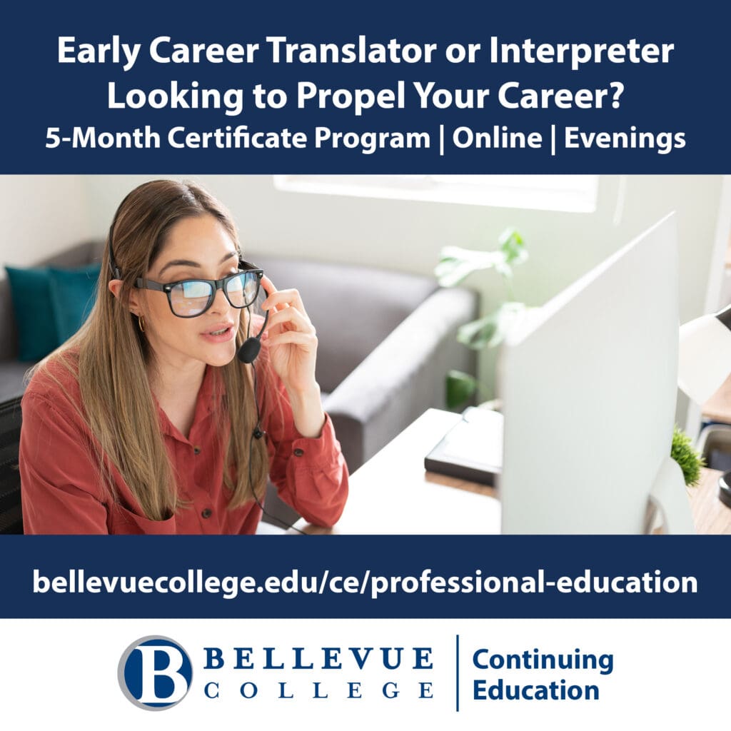 woman at computer with headphones on talking into headset