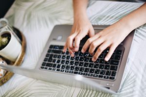 Student typing on laptop
