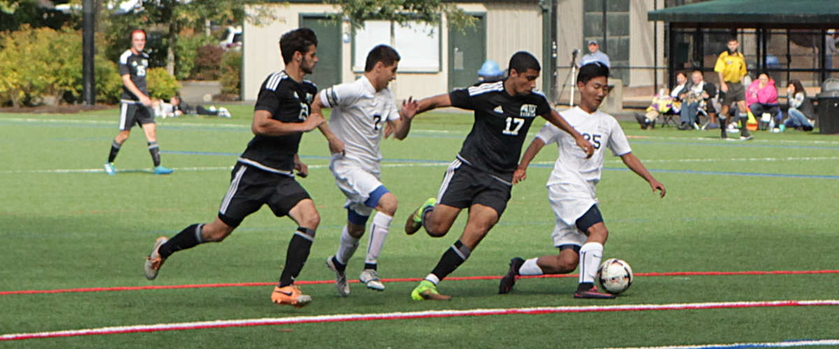 Two BC players battle against two Tacoma defenders in a men's soccer match