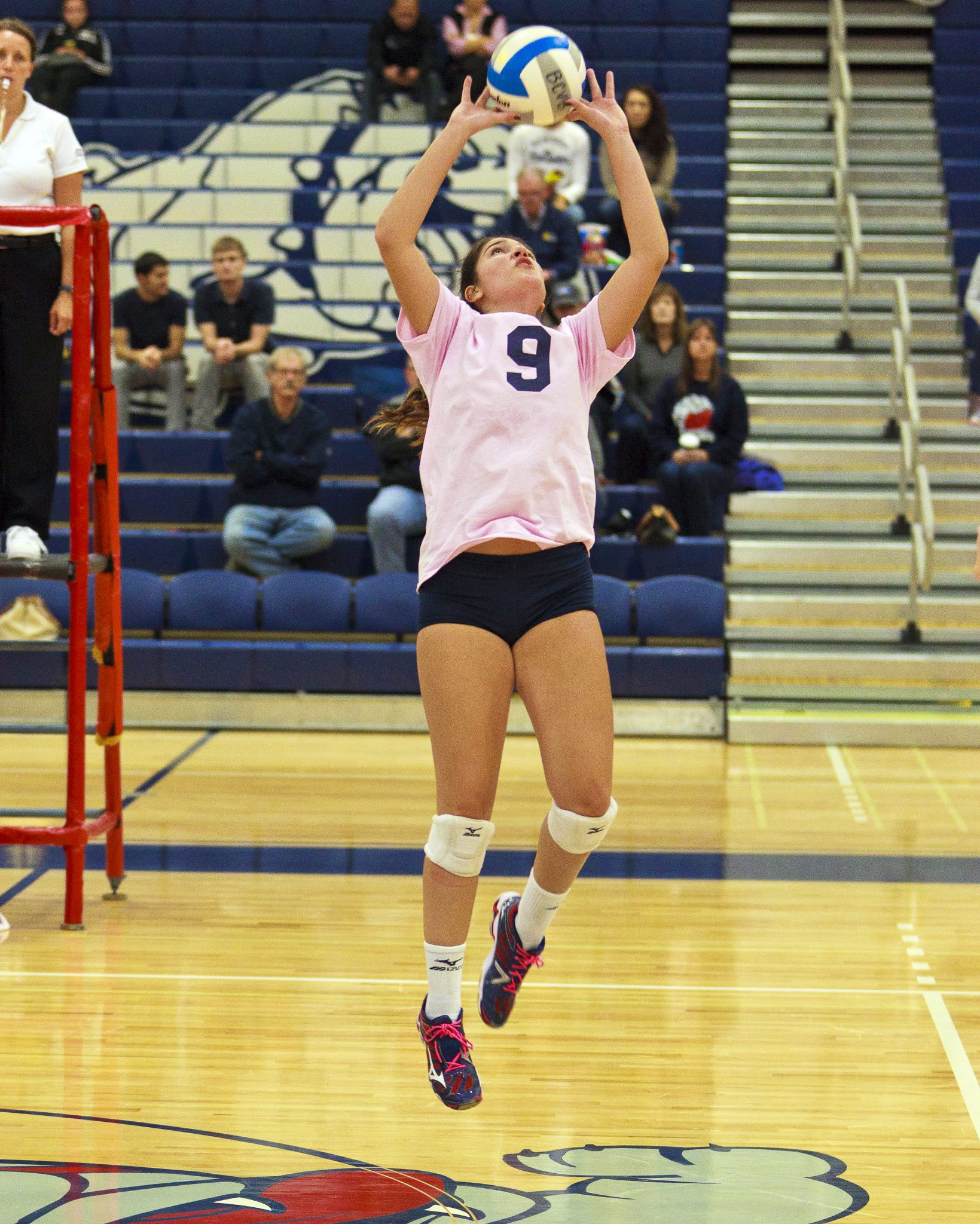 A Bellevue College volleyball player sets the ball for teammates