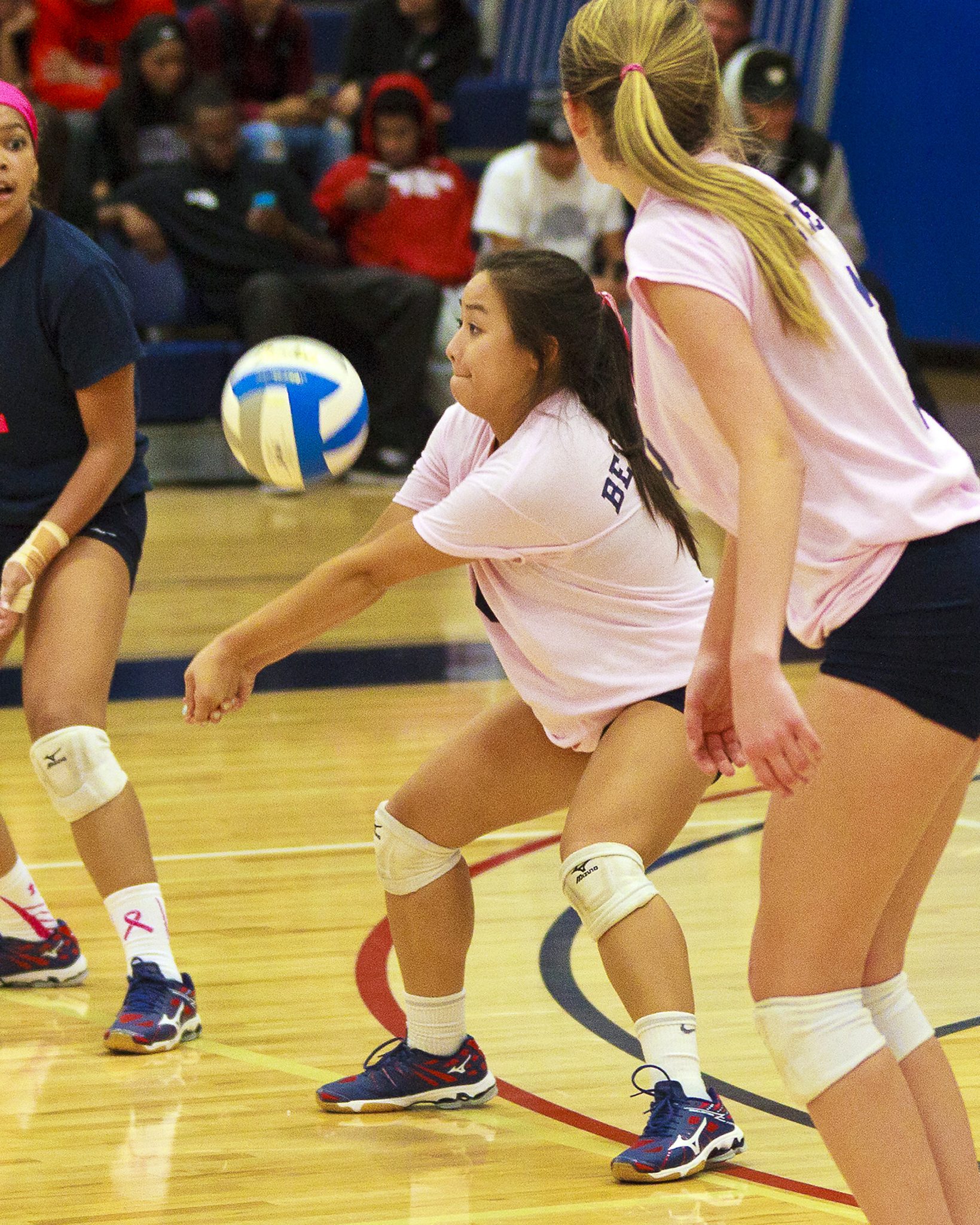 A Bellevue College volleyball player returns a shot