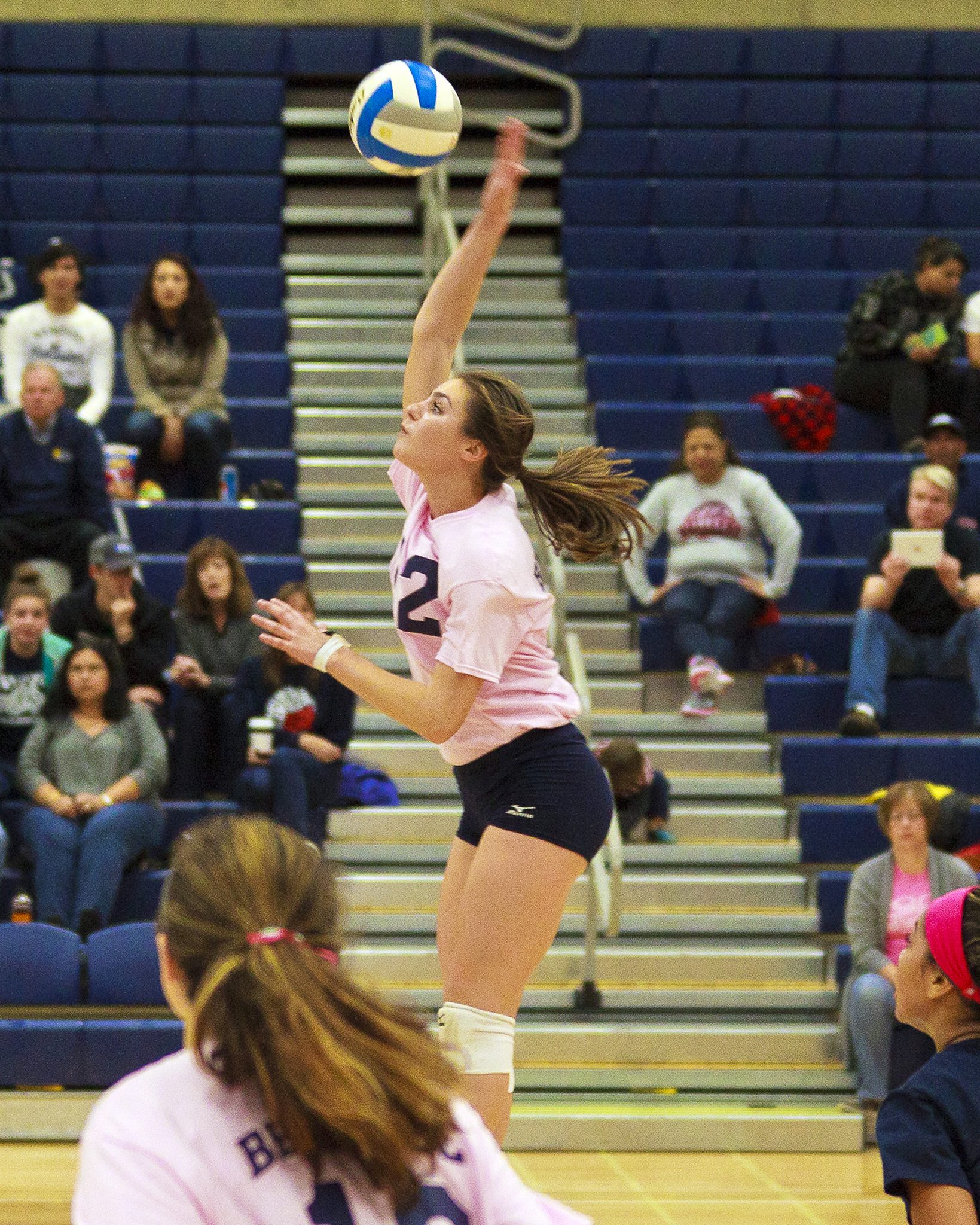 A Bellevue College volleyball player hits a shot