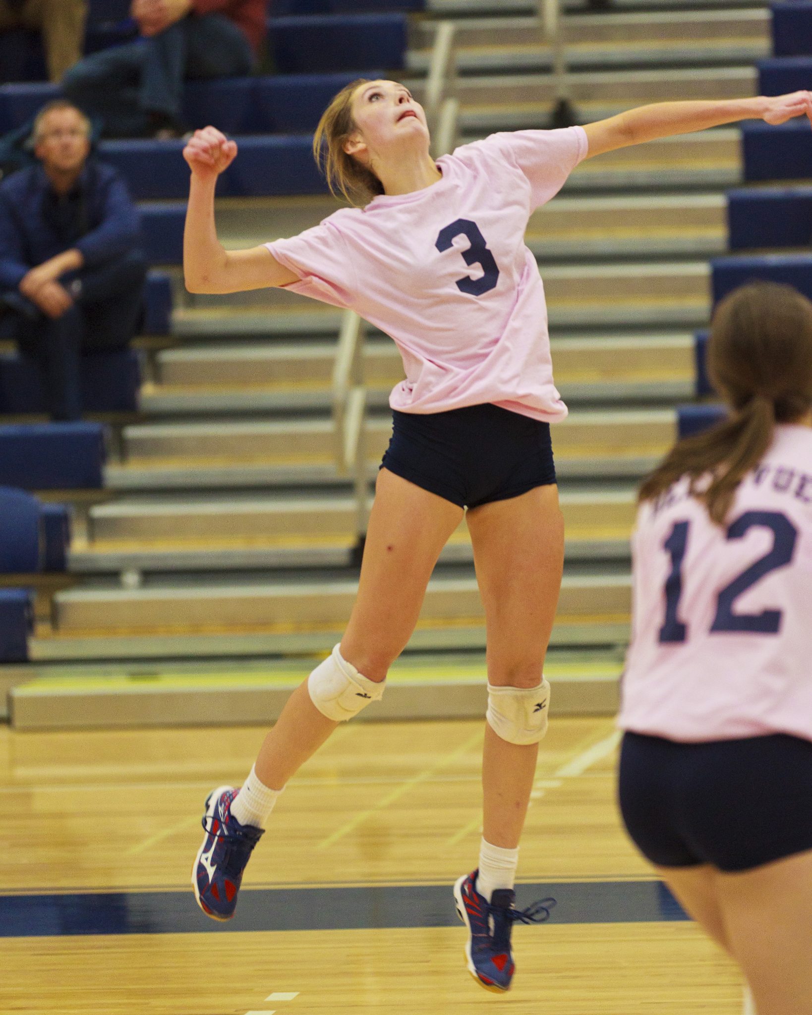 A Bellevue College volleyball player hits a shot