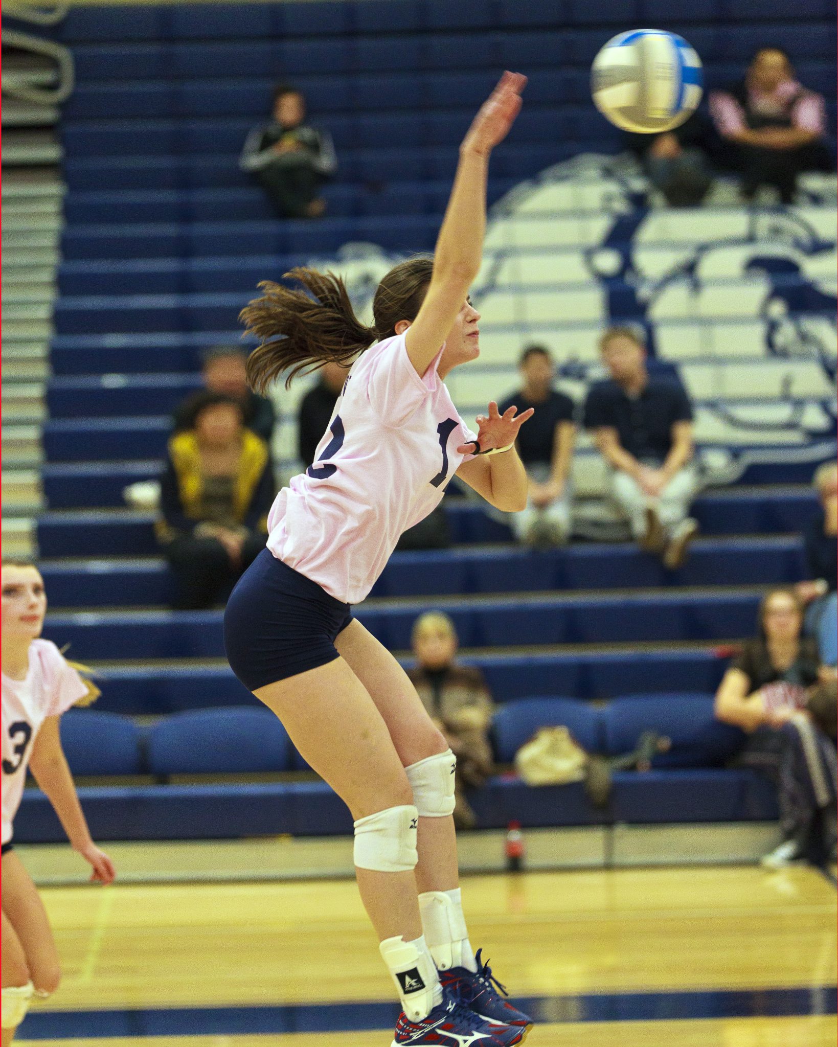 A Bellevue College volleyball player hits a shot