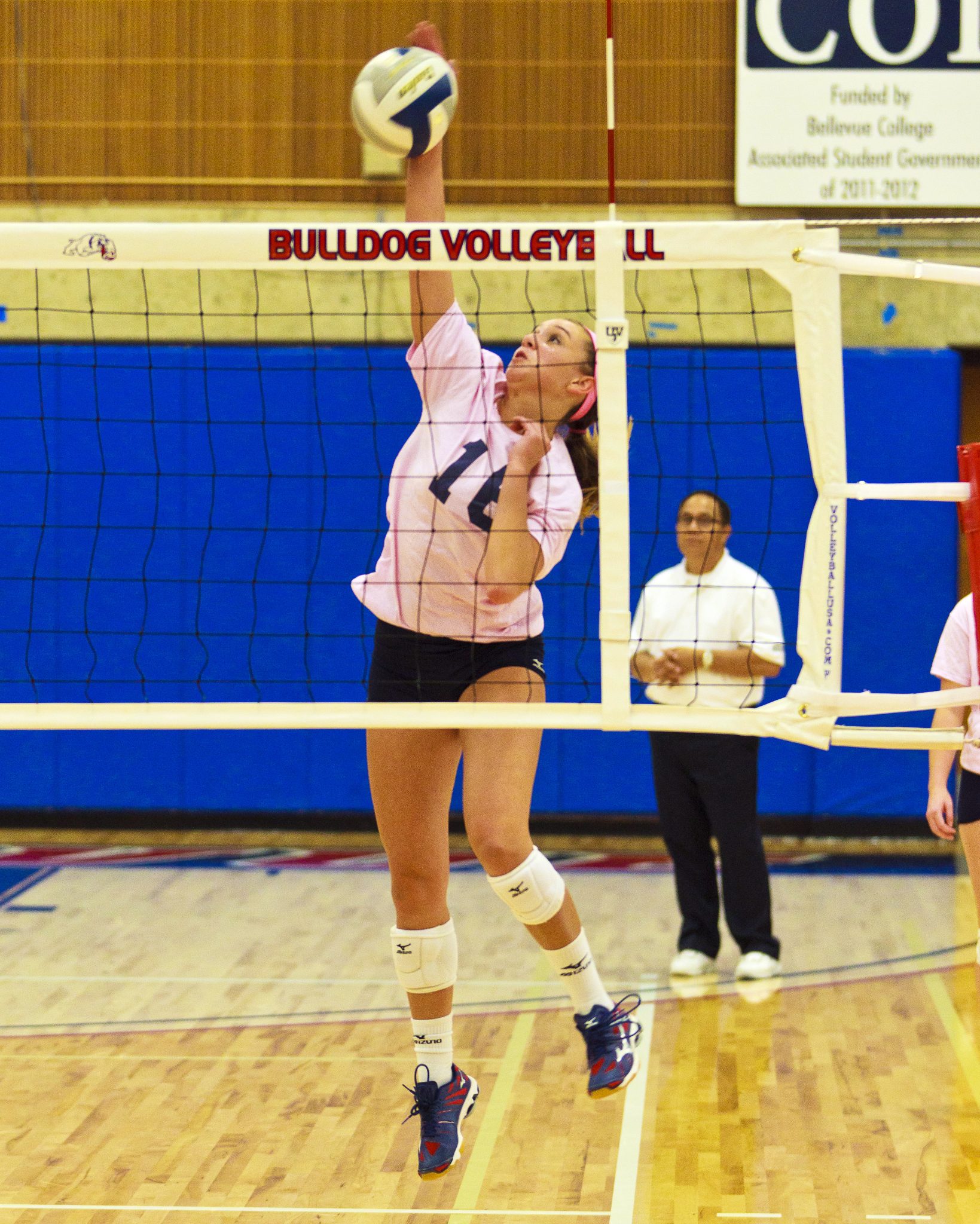 A Bellevue College volleyball player hits a shot