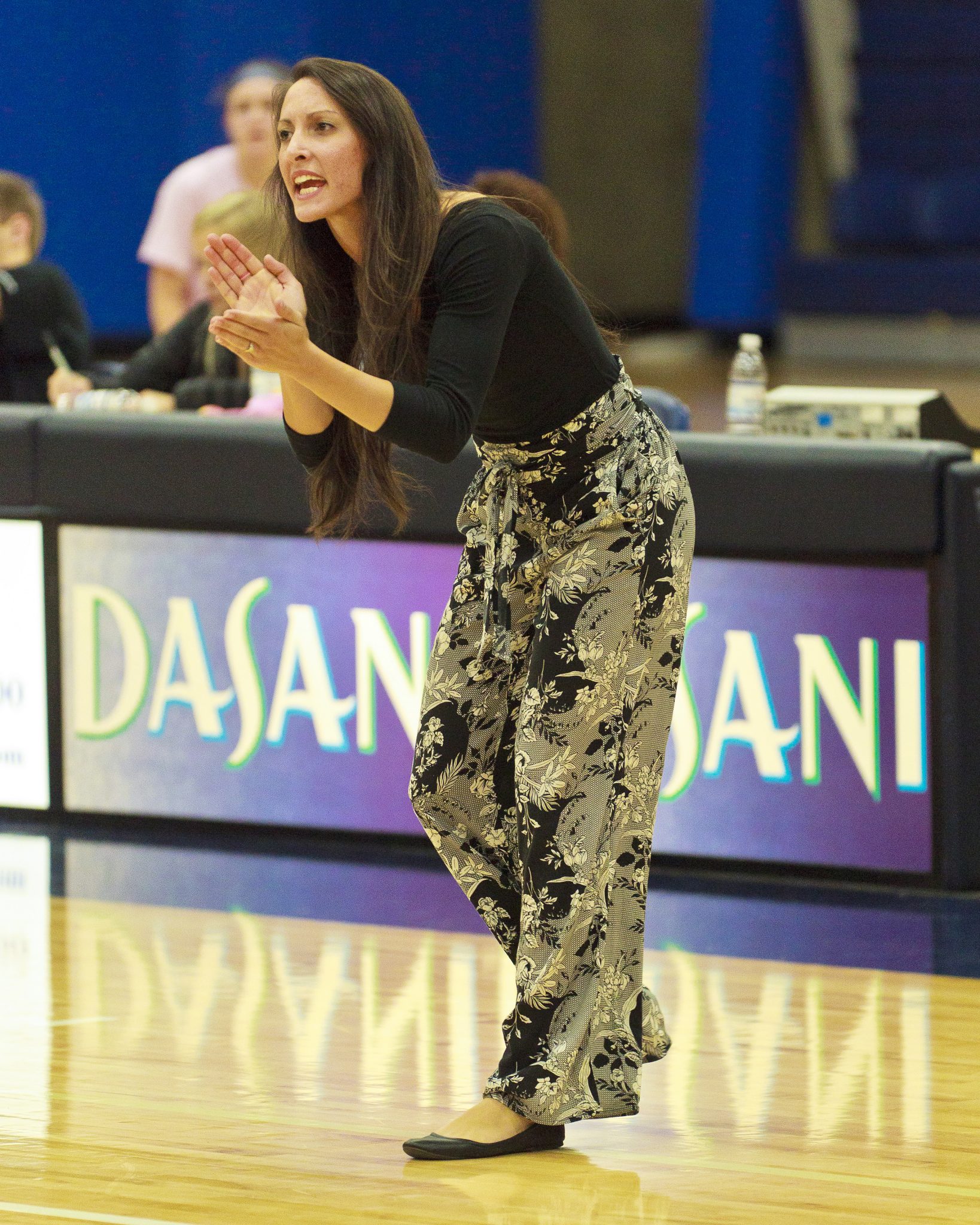 Bellevue College volleyball coach Jocelyn Lawrence encourages her team