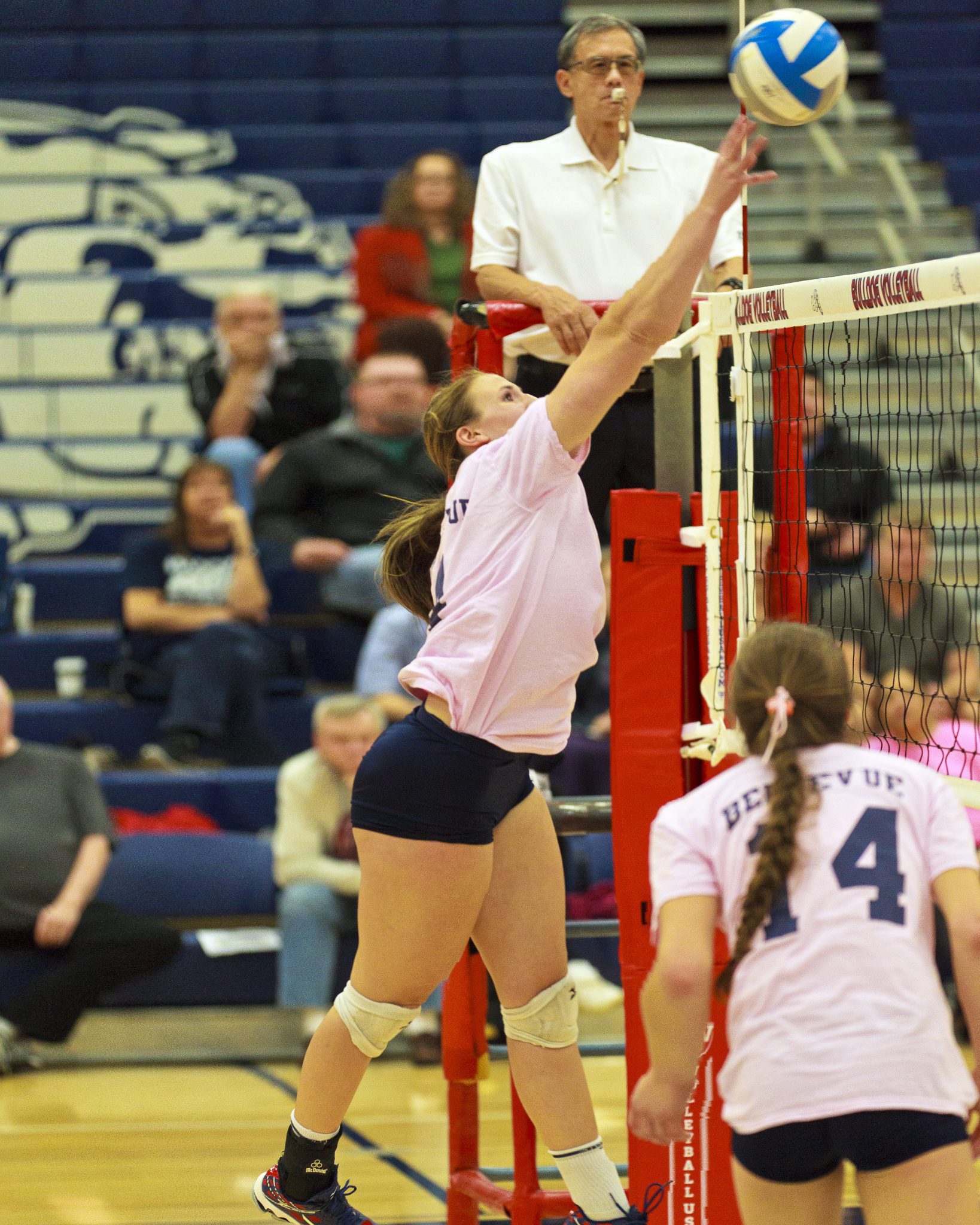 A Bellevue College volleyball player hits a shot