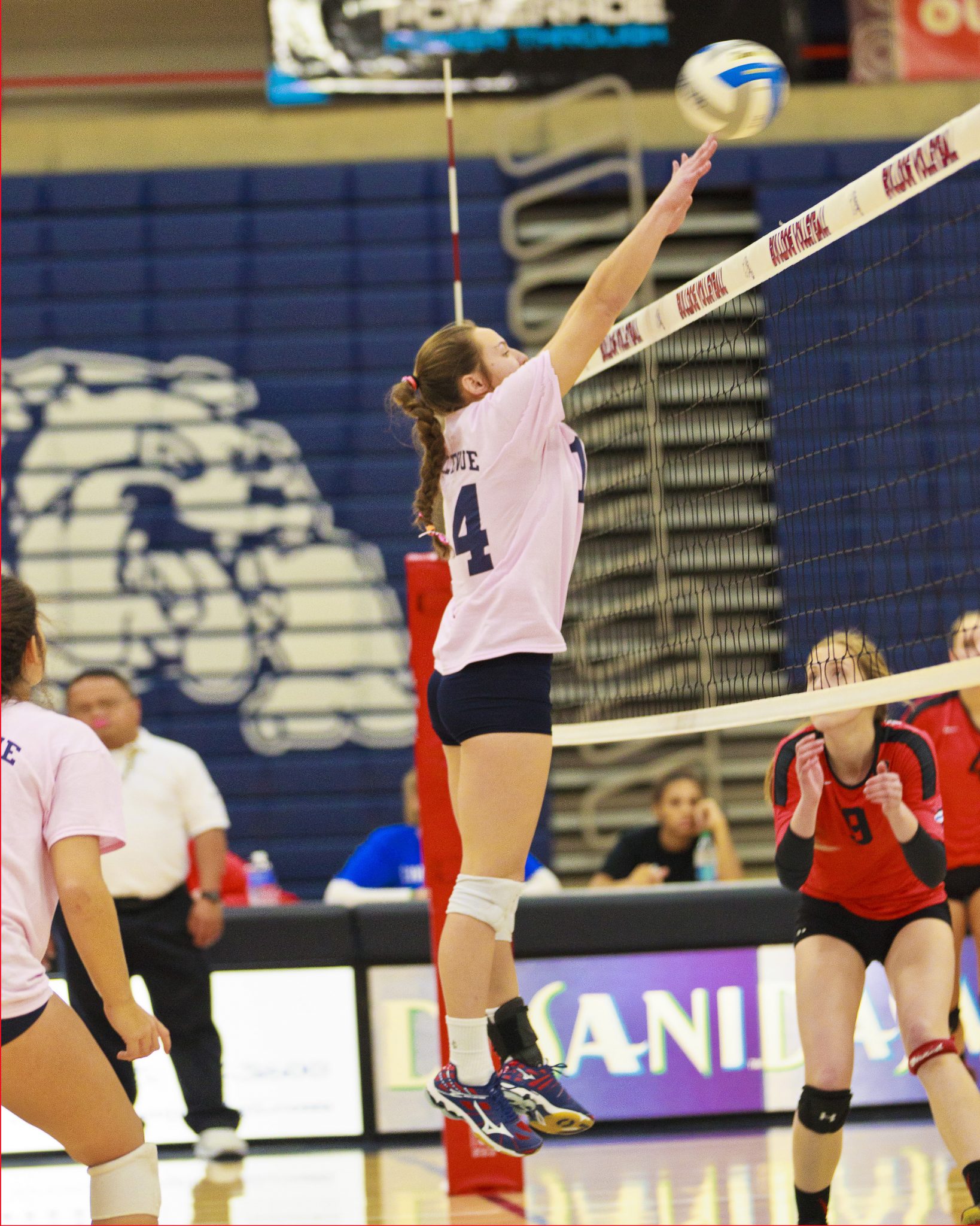 A Bellevue College volleyball player hits a shot