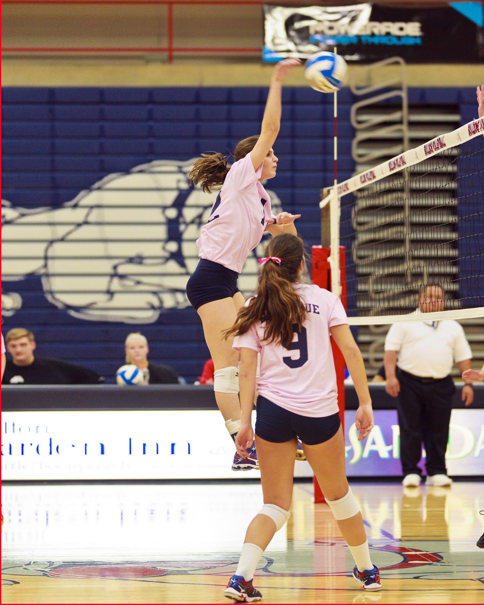 A Bellevue College volleyball player hits a shot