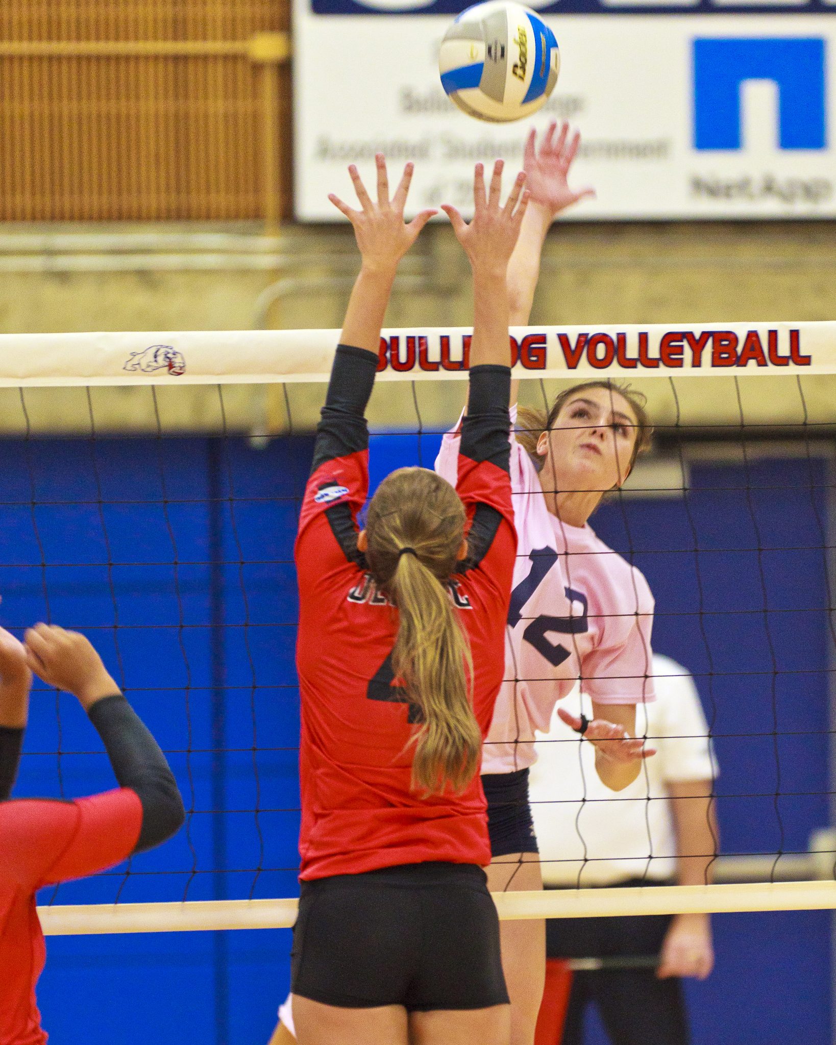 A Bellevue College volleyball player hits a shot