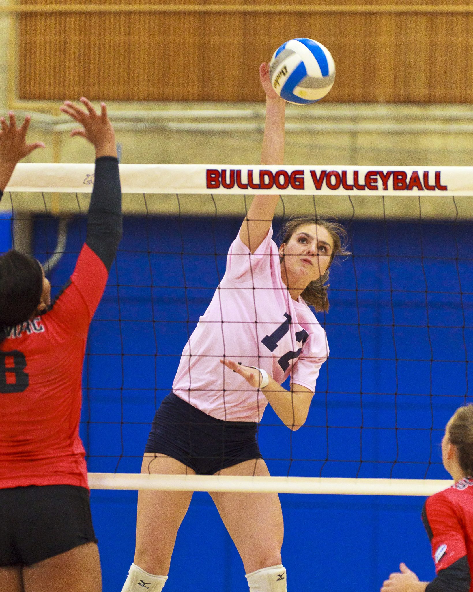 A Bellevue College volleyball player hits a shot