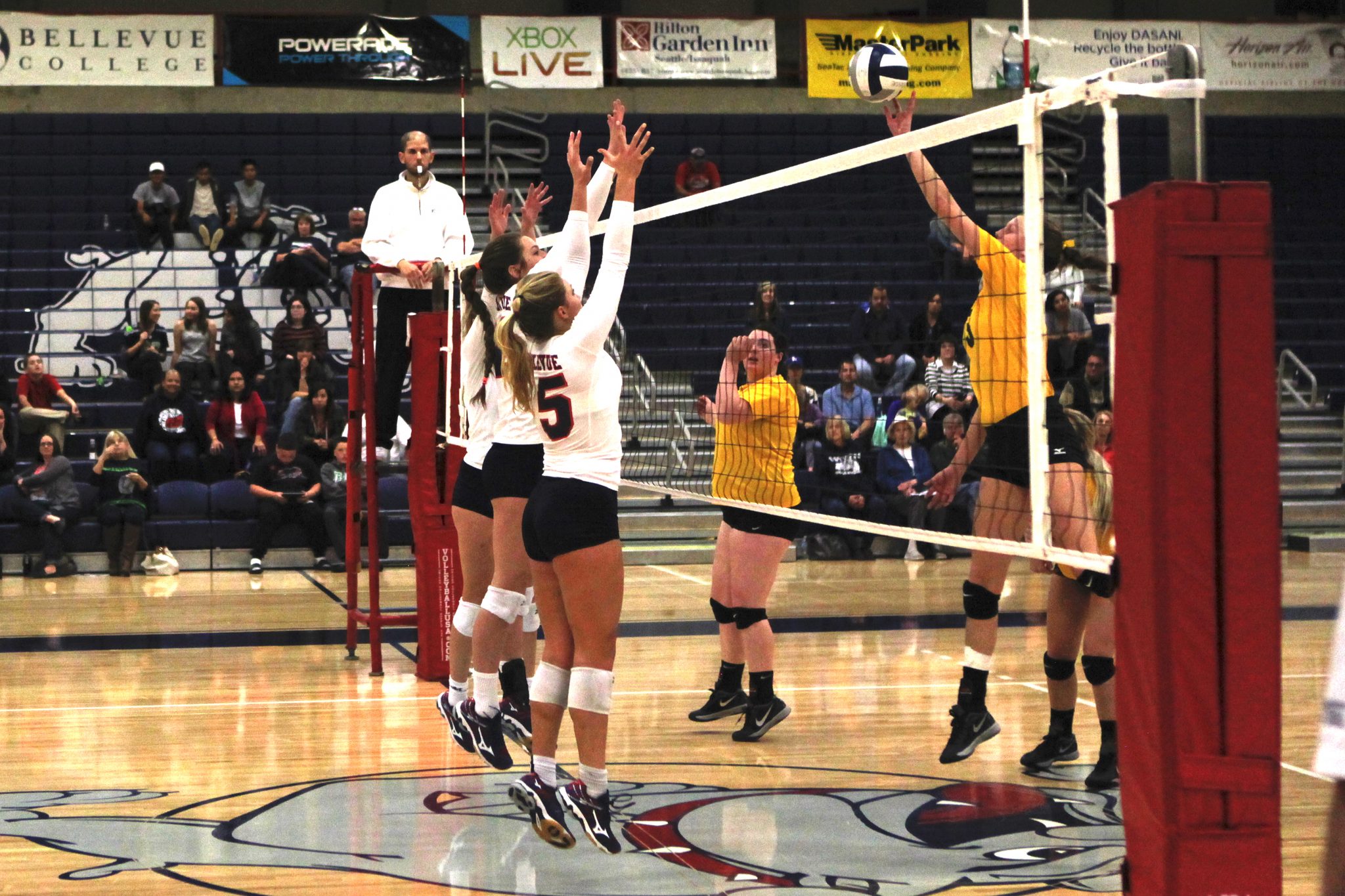 Three Bellevue College players go for the block against Shoreline