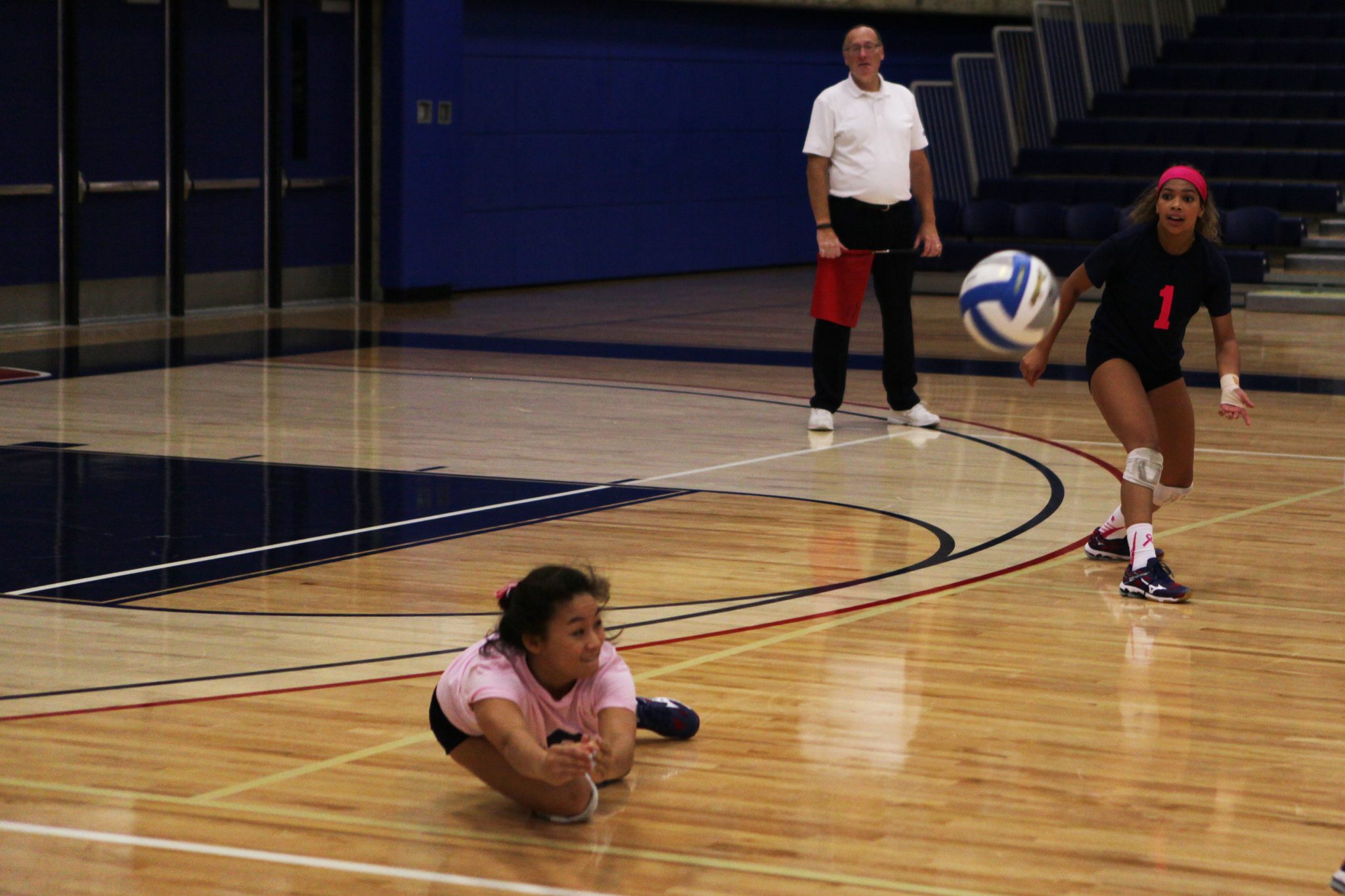 A Bellevue College player makes a diving return against Olympic