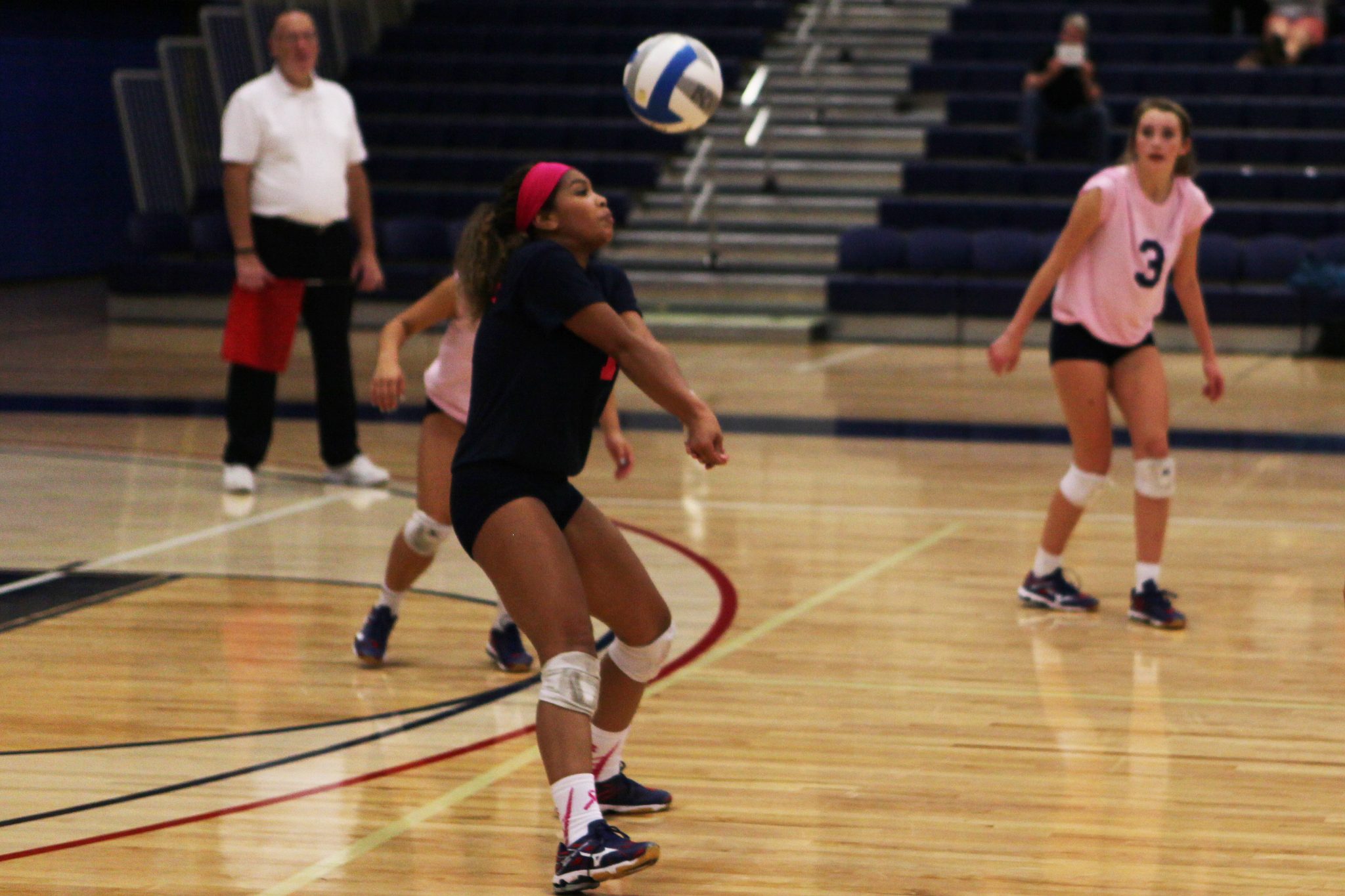 A Bellevue College player sets a shot in a volleyball match against Olympic