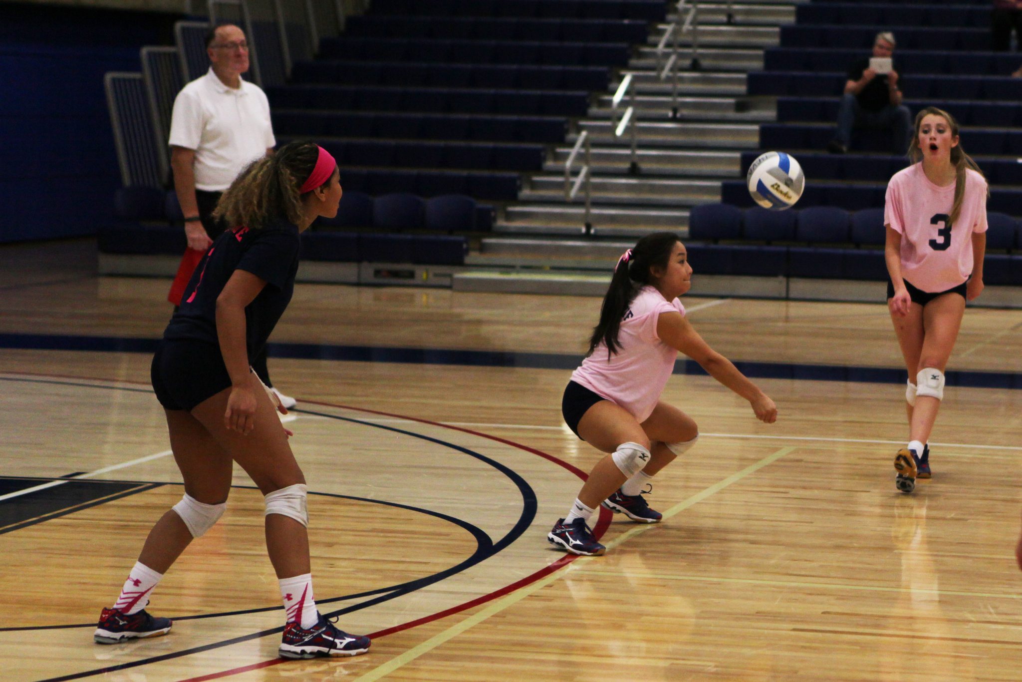 A Bellevue College player sets a shot in a volleyball match against Olympic