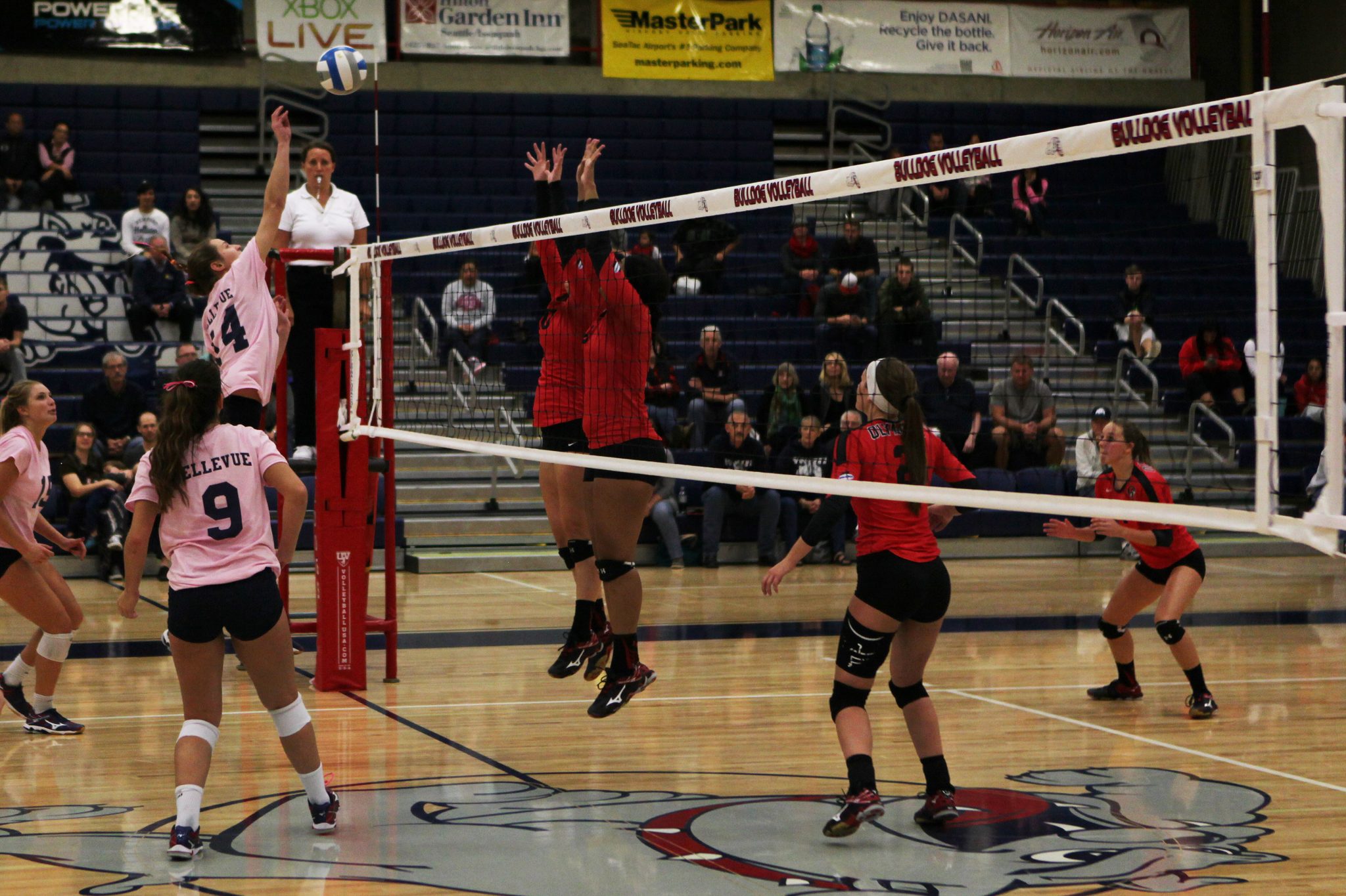 A Bellevue College player hits a shot in a volleyball match against Olympic