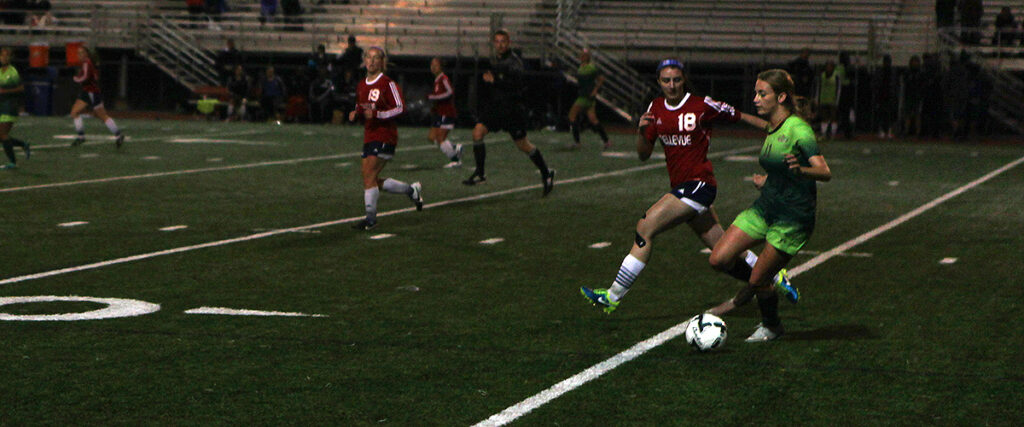 Bellevue College's Jessica Walters defends against a Highline player in a women's soccer match