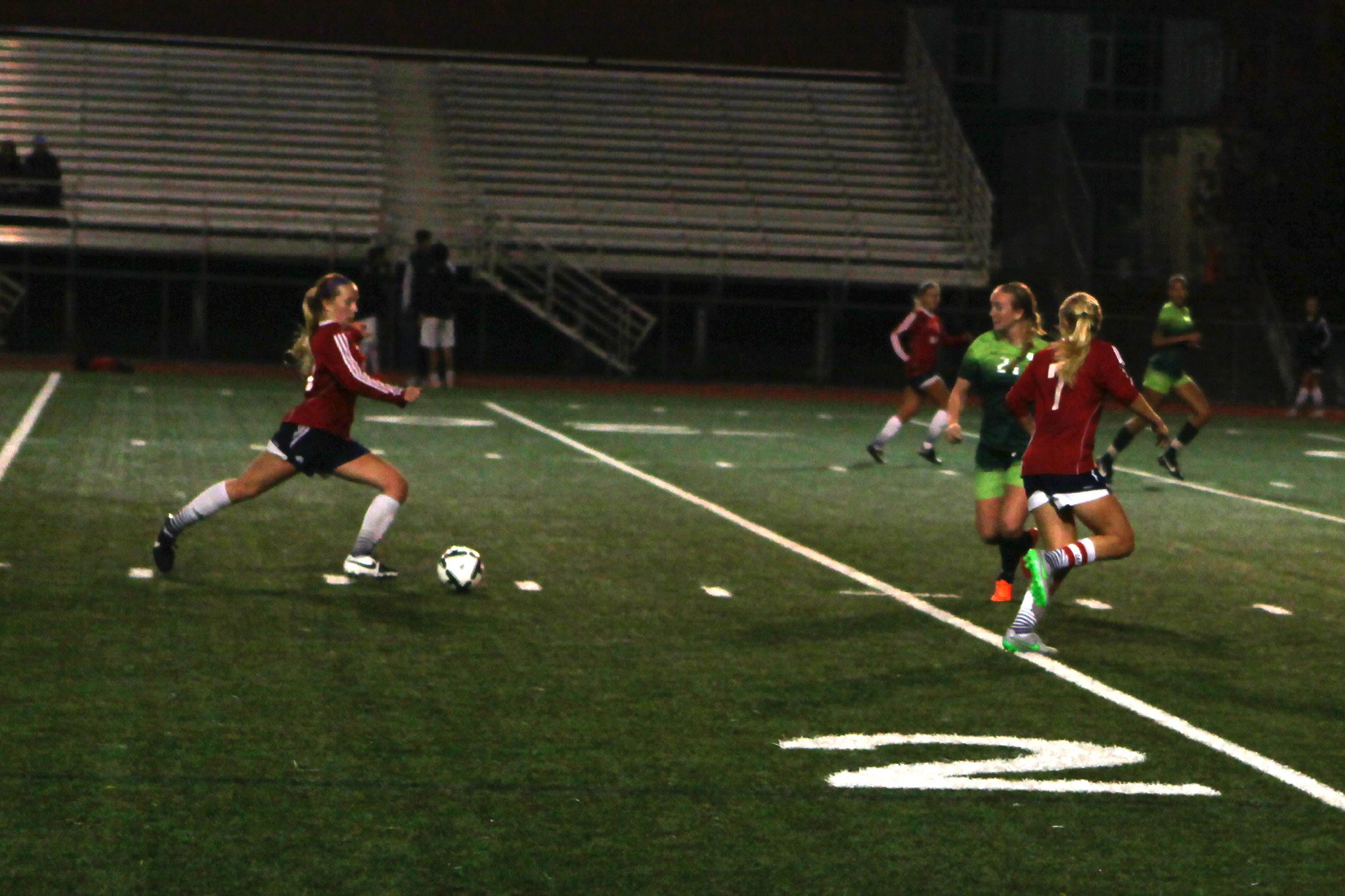 A Belleve Colllege player advances the ball against Highline in a women's soccer match