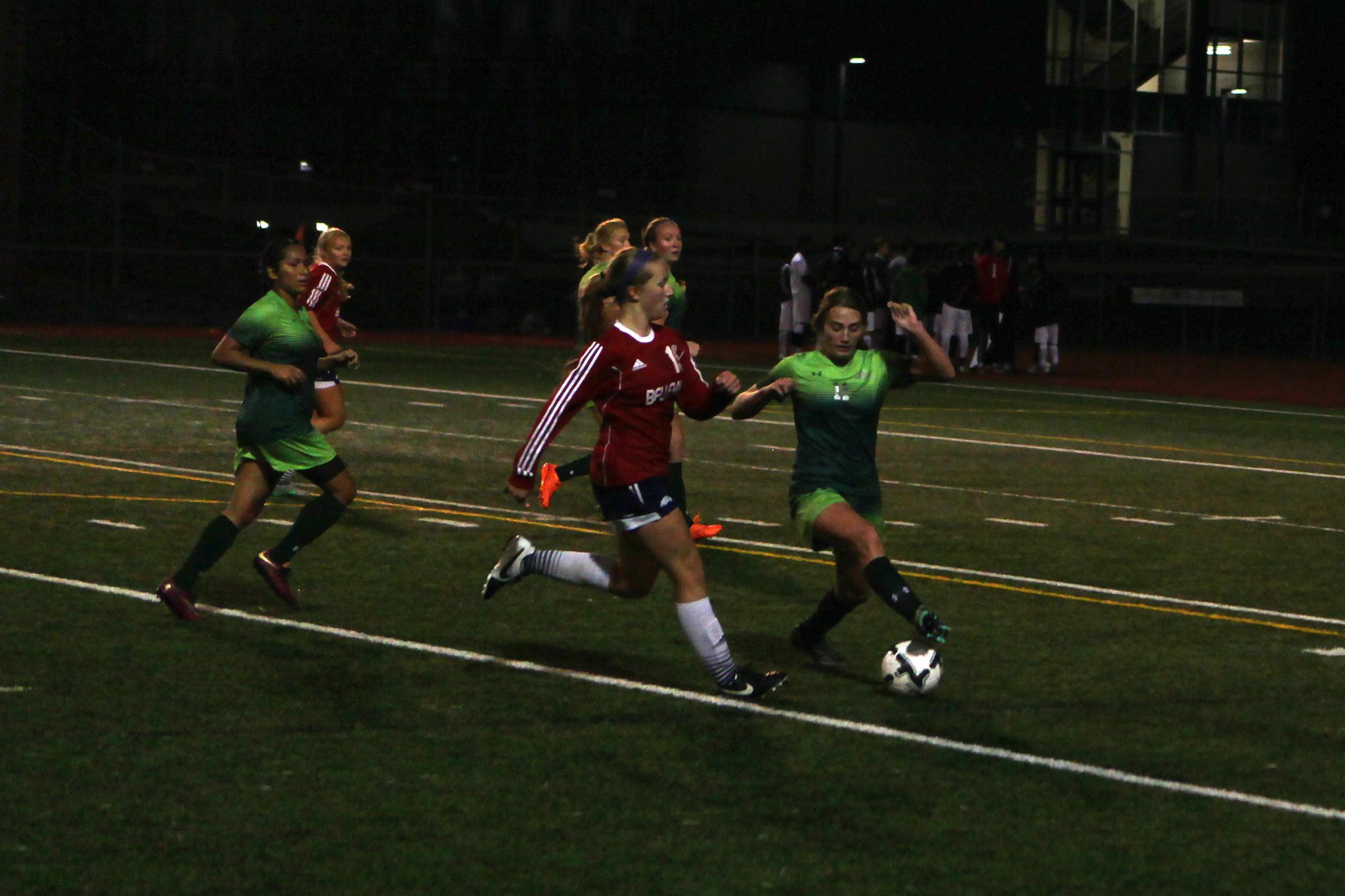 A Belleve Colllege player advances the ball against Highline in a women's soccer match