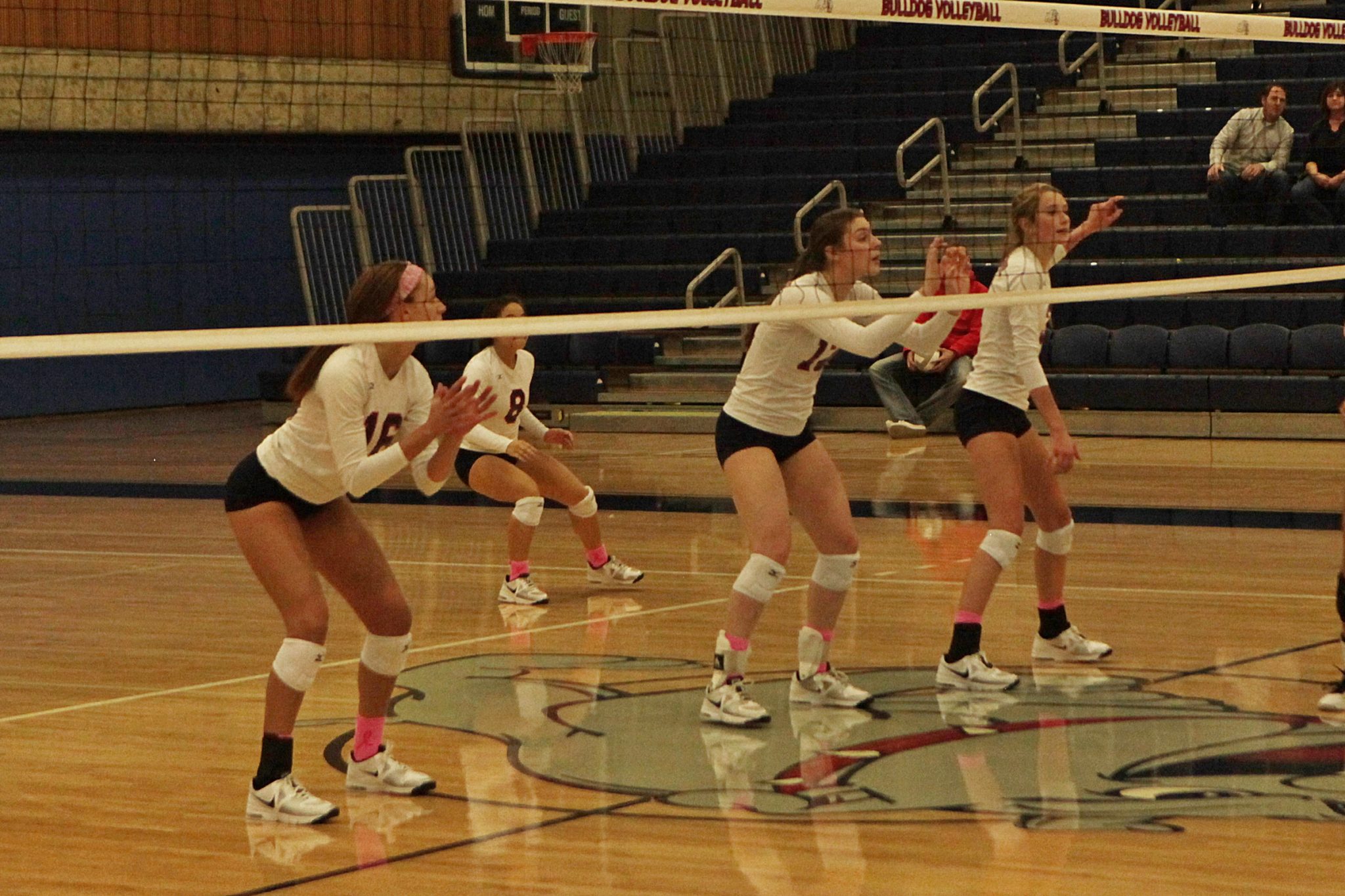 BC volleyball players await the serve