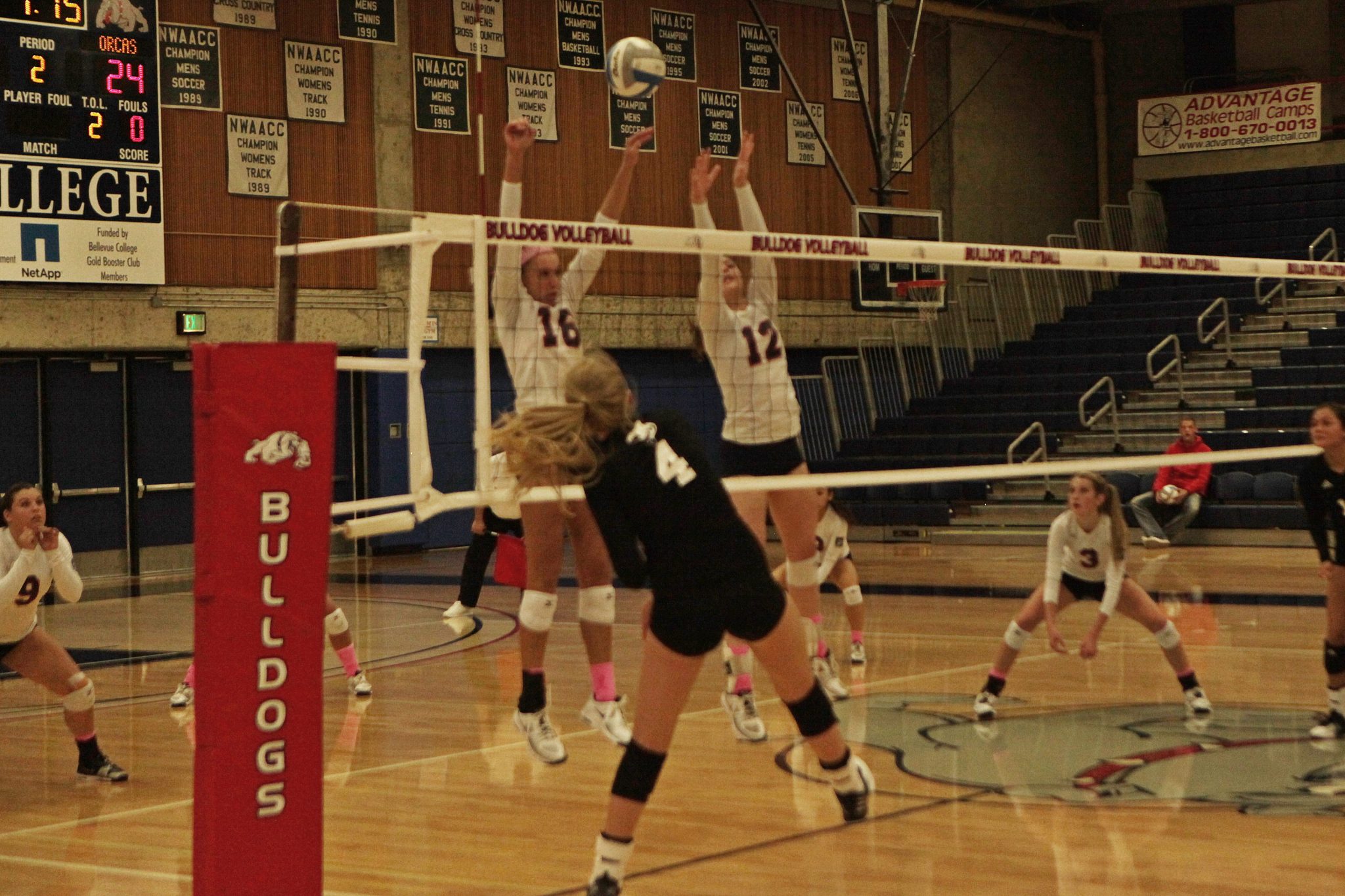 Two BC volleyball players go up for the block against Whatcom