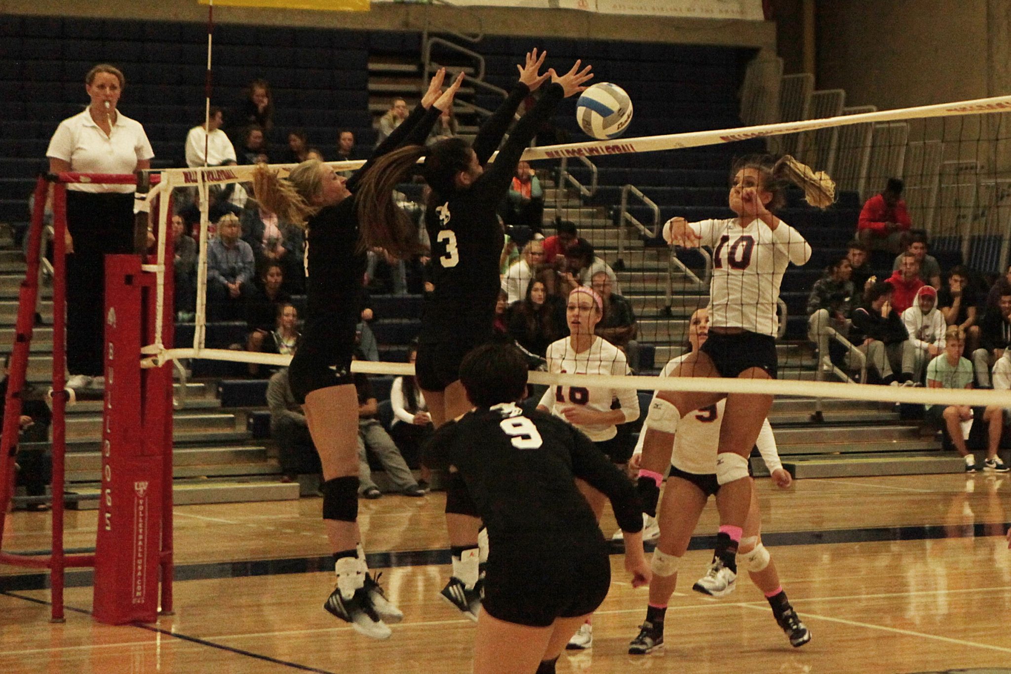 Two Whatcom players go up for the block against at BC player