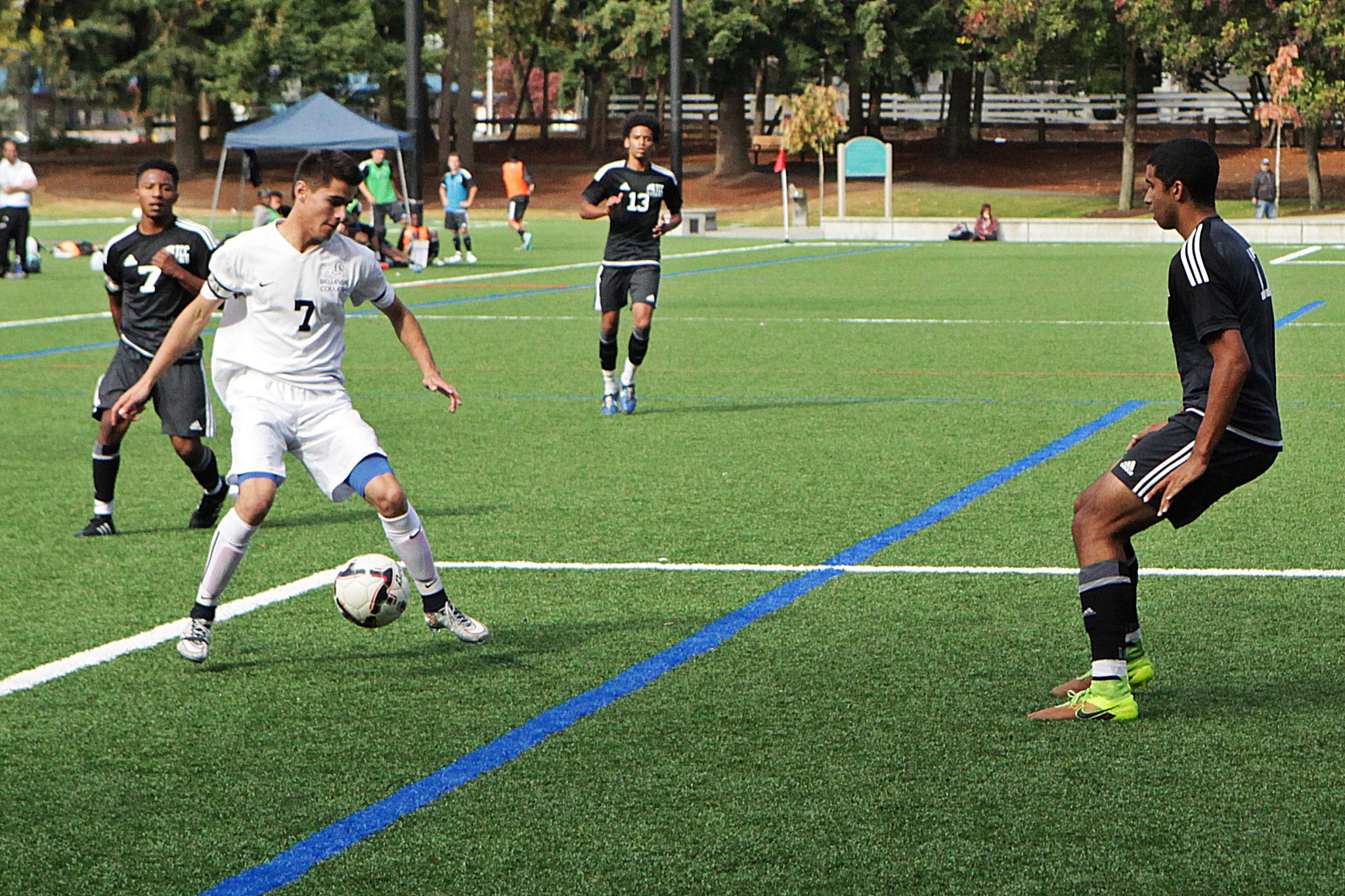 A BC men's soccer player kicks the ball vs. Tacoma