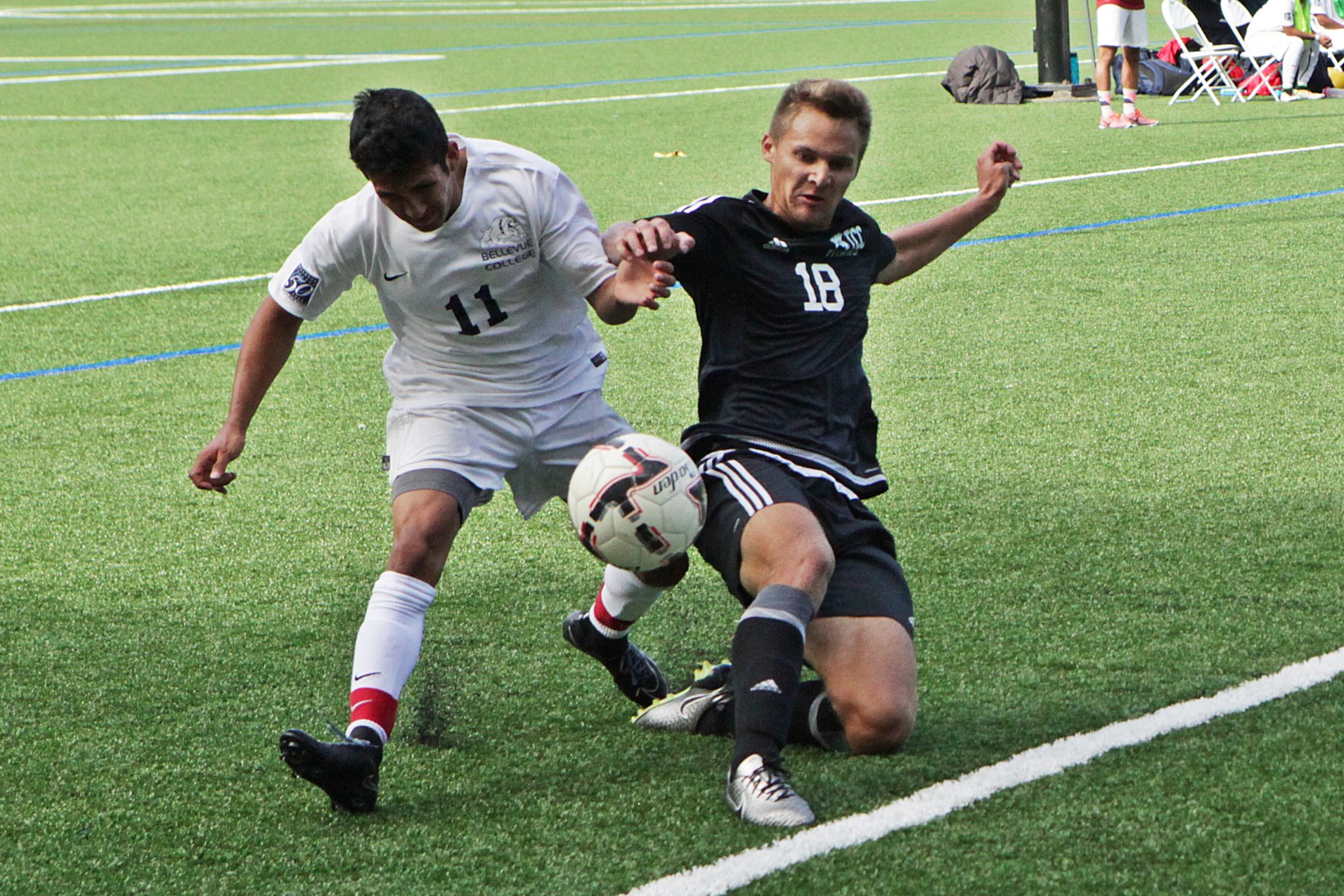 A BC men's soccer player battles a Tacoma player for the ball