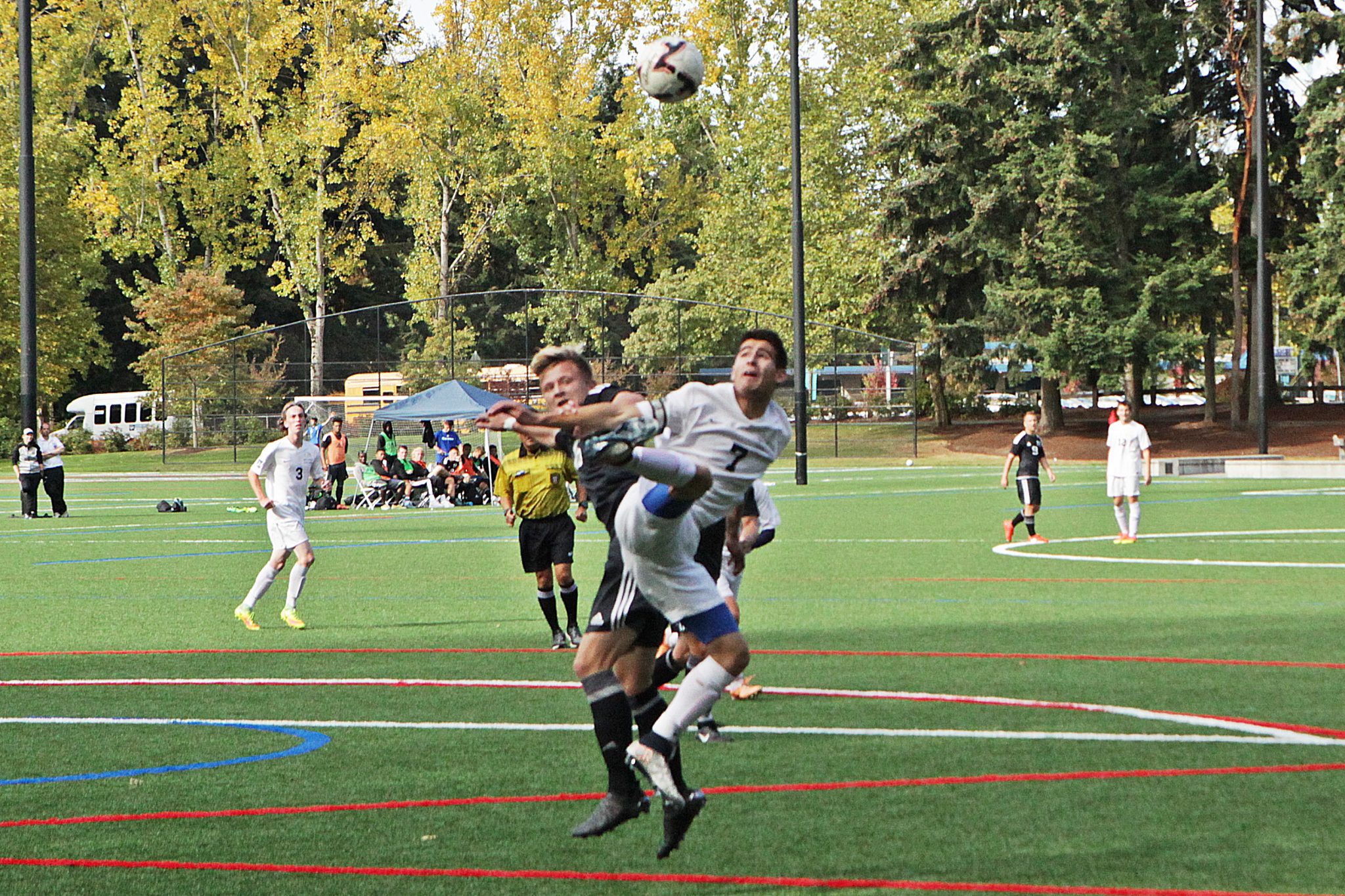 A BC men's soccer player battles a Tacoma player for the ball