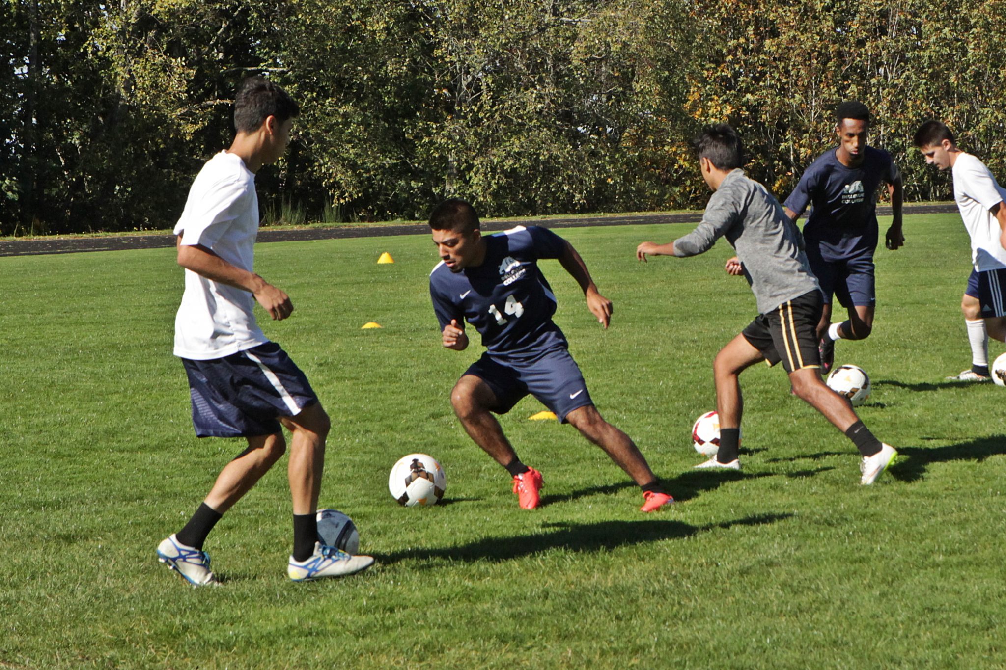 BC men's soccer players take part in ball control and passing drills at practice
