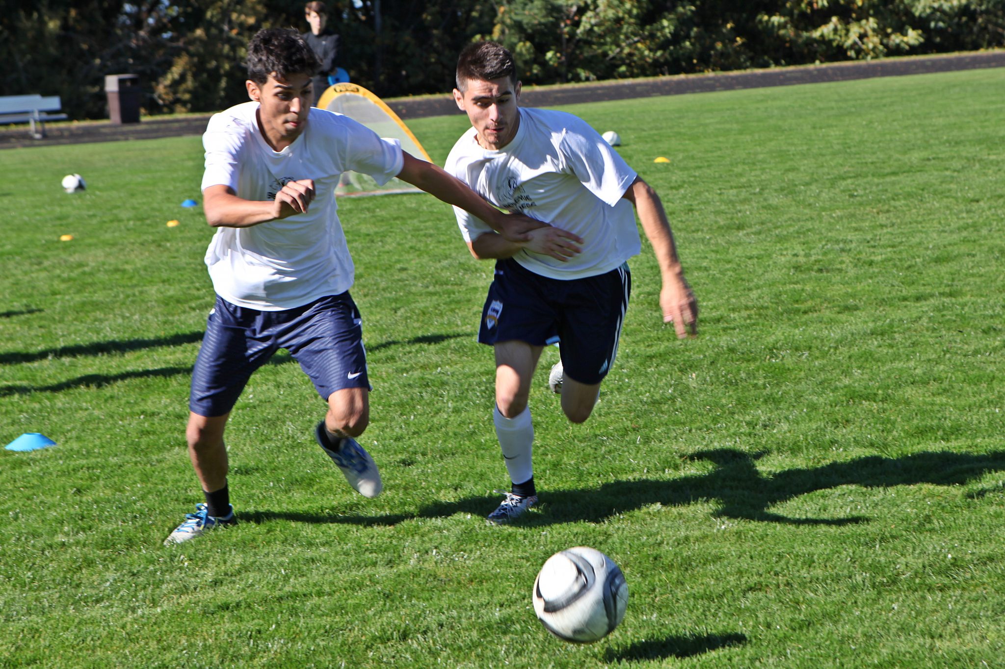 BC men's soccer players take part in ball control and passing drills at practice