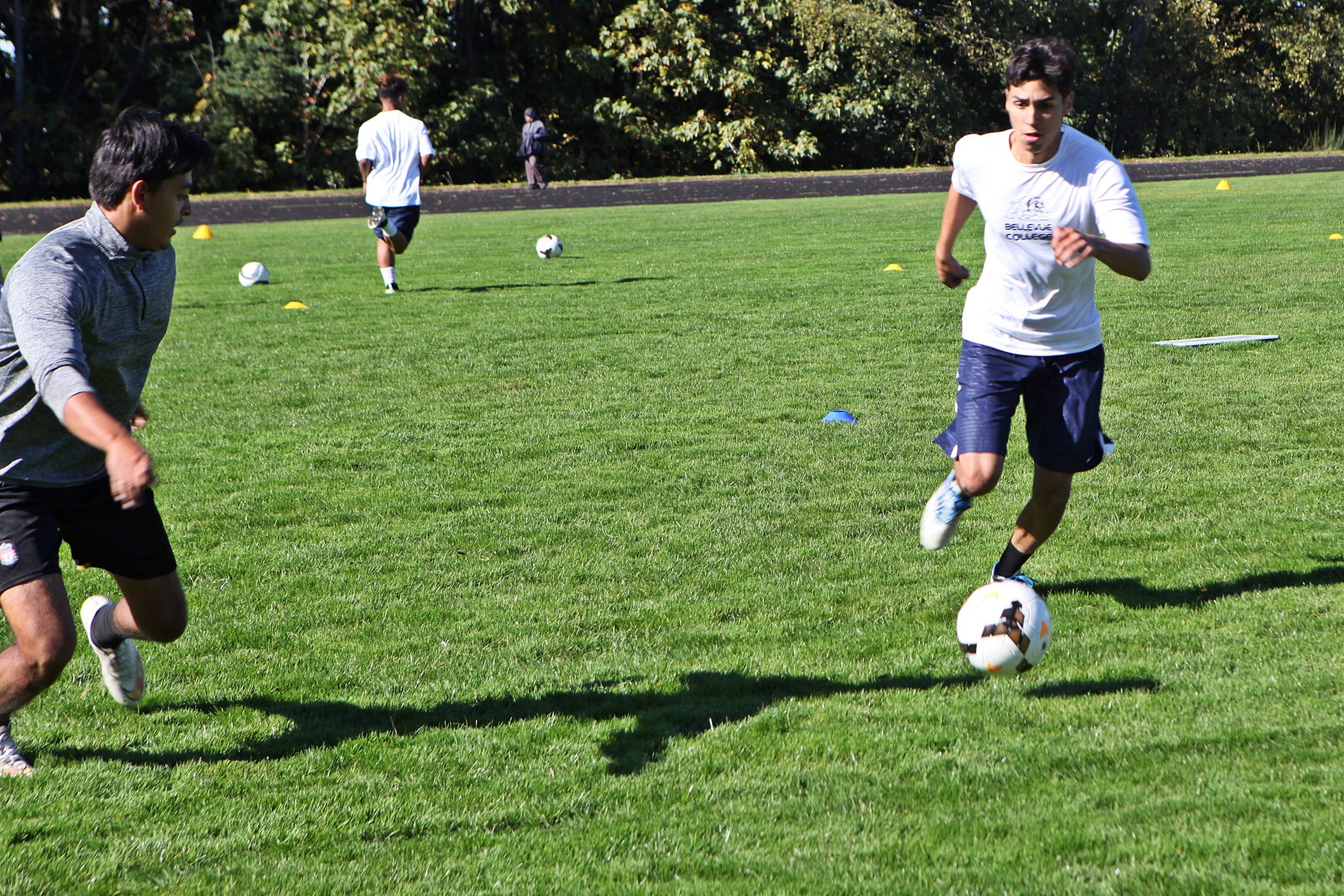 BC men's soccer players take part in ball control and passing drills at practice
