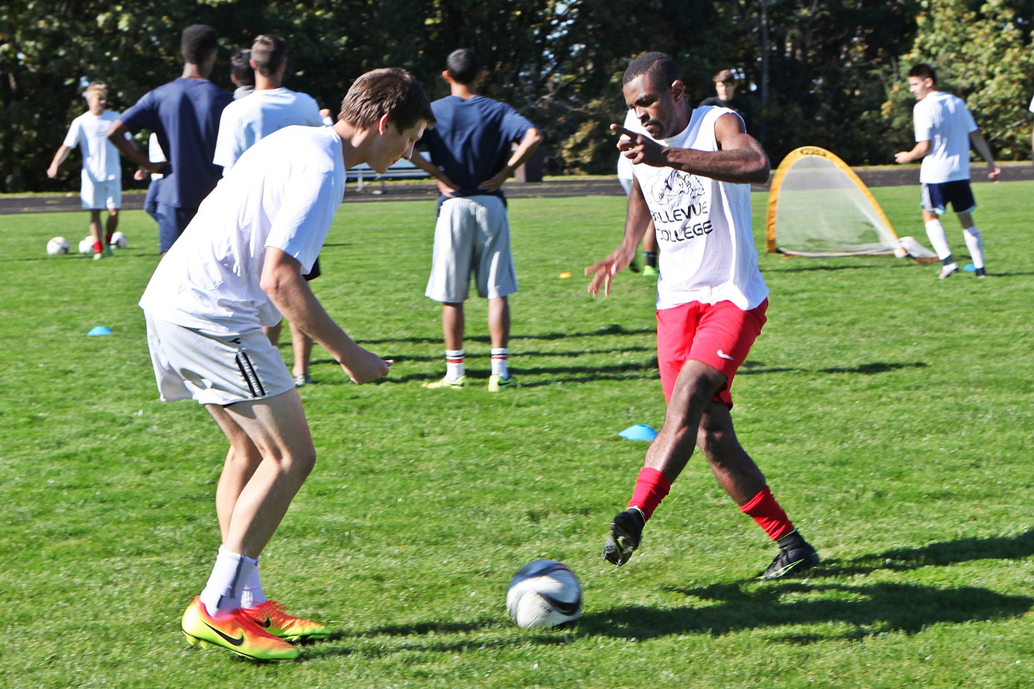 BC men's soccer players take part in ball control and passing drills at practice