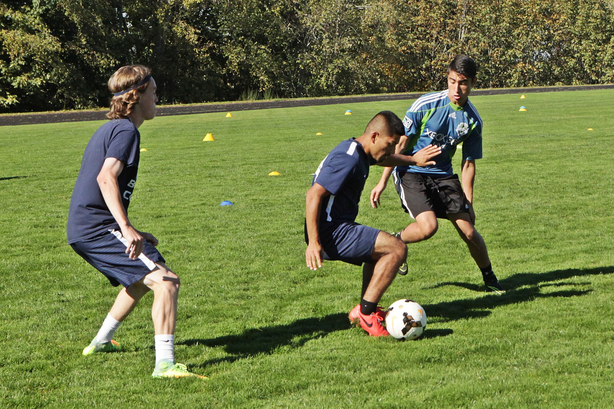 BC men's soccer players take part in ball control and passing drills at practice