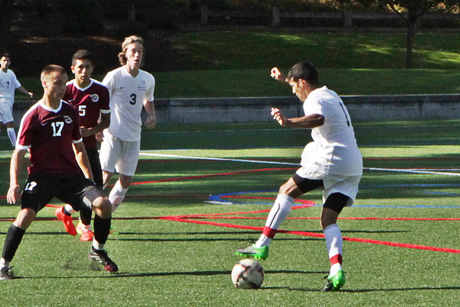 A BC men's soccer player kicks the ball against Pierce