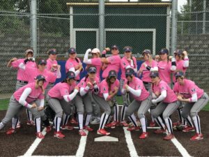 Bellevue College softball team in pink jersey