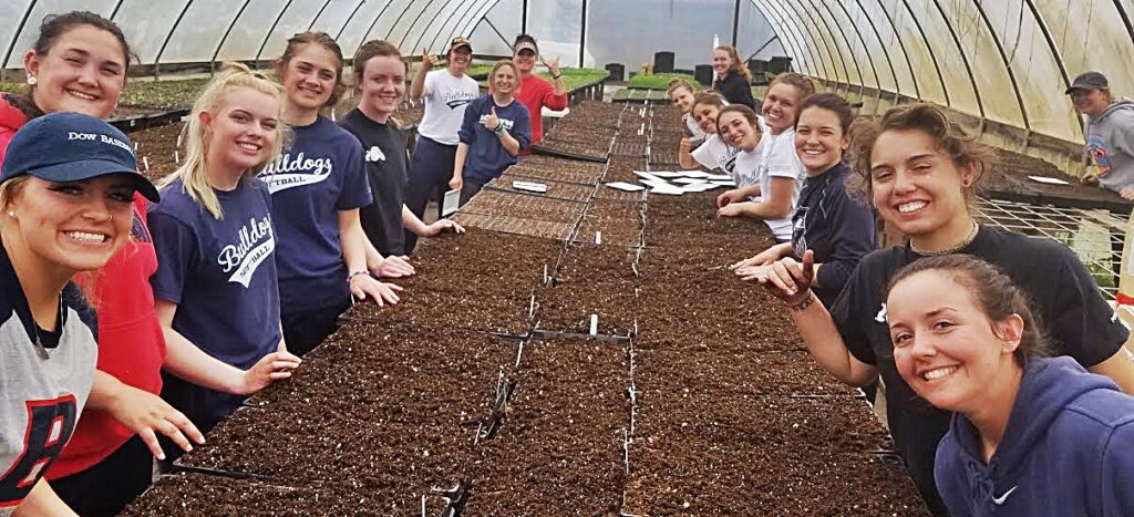 Bellevue College softball players and coaches helped plant seeds at a local farm