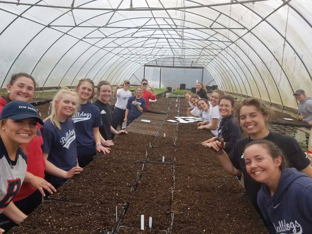 BC softball performs community service at a farm