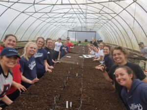 BC softball performs community service at a farm