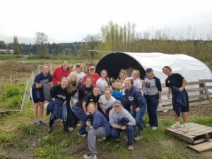 BC softball performs community service at a farm