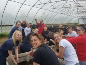 BC softball performs community service at a farm