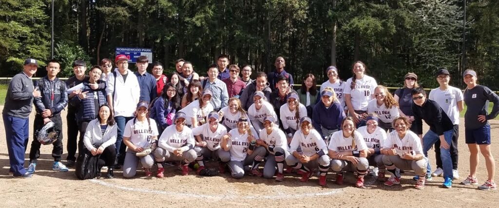 The BC softball team poses with international students in a group photo