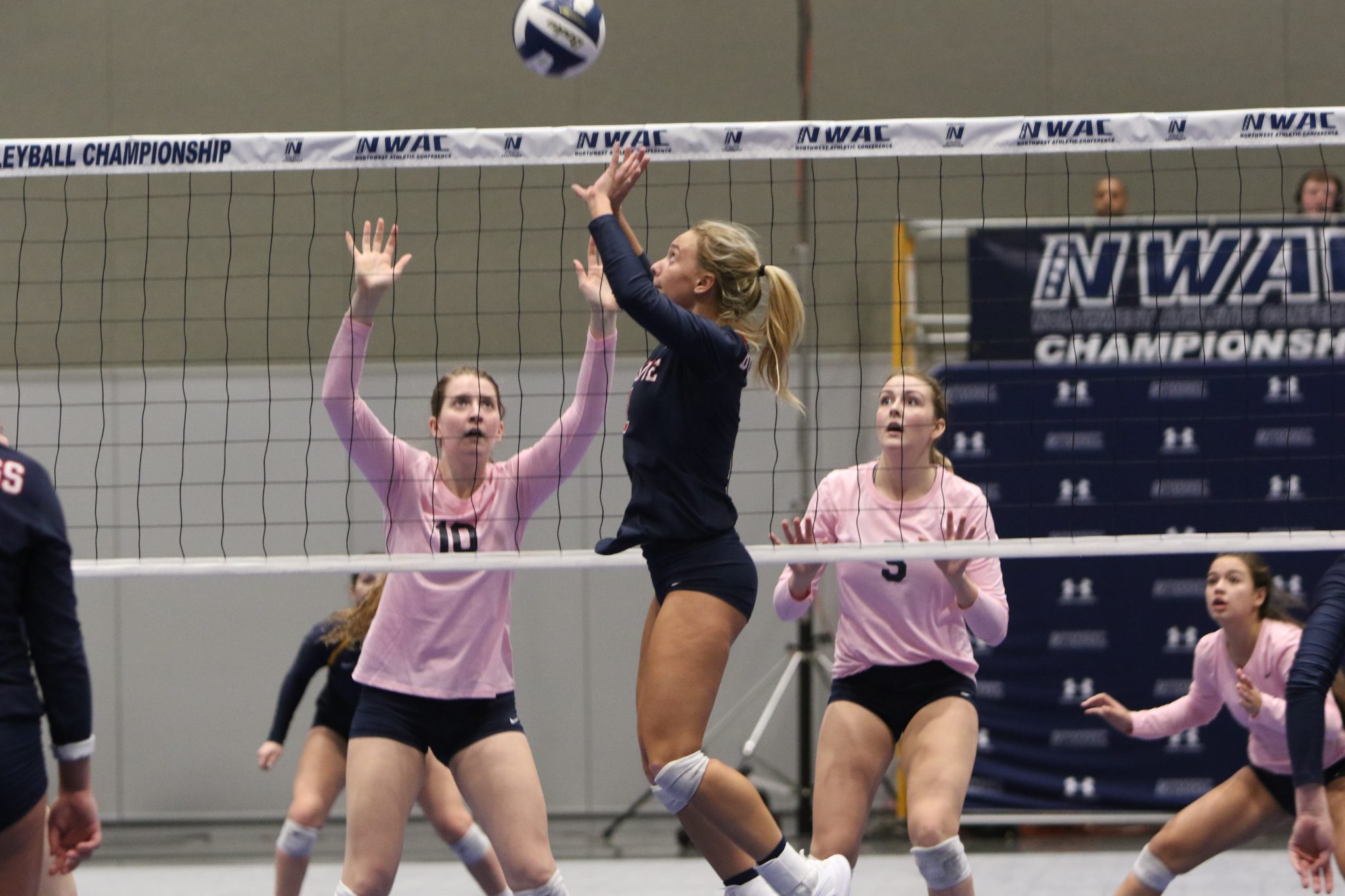 A BC player does a set pass at the net
